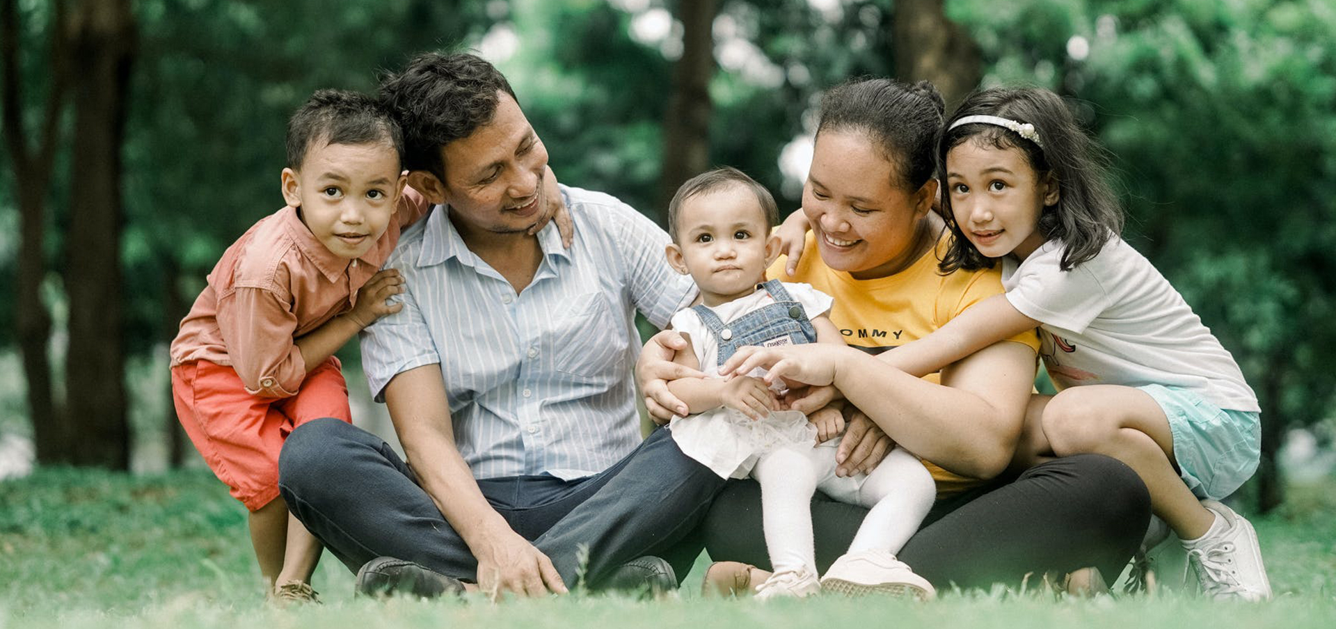 Filipino family sitting in grass